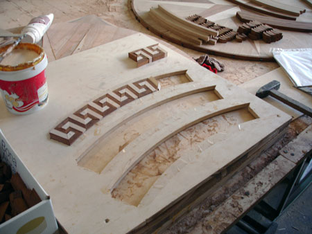 Wood Floor Medallion assembled from CNC cut pieces into the intricate inlay Assembling Inlay pieces together
