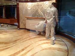 Hand applied wood finish in dust protective gear